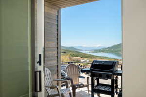 Balcony with a grill and a water and mountain view