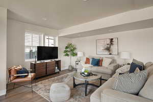 Living room featuring wood finished floors, baseboards, and recessed lighting