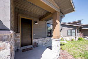 Property entrance featuring stone siding