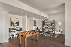 Game room featuring wood finished floors, baseboards, and recessed lighting
