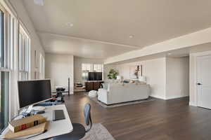 Home office with dark wood-style flooring, baseboards, and recessed lighting