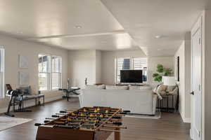 Recreation room featuring baseboards, dark wood-type flooring, and recessed lighting