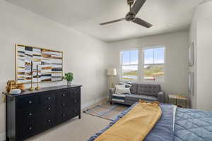 Bedroom with light carpet, baseboards, and ceiling fan