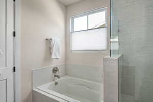 Full bathroom with a garden tub and a stall shower