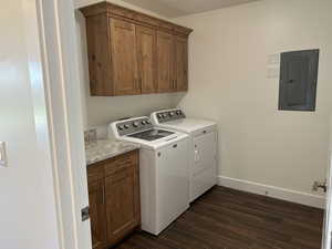 Washroom featuring electric panel, independent washer and dryer, cabinet space, and dark wood-style flooring