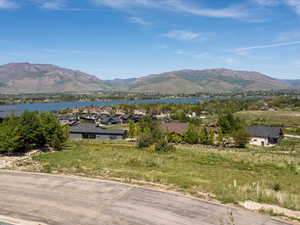 View of mountain backdrop with a nearby body of water and nearby suburban area