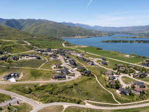 Aerial overview of property's location featuring a water and mountain view