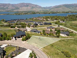 Aerial perspective of suburban area featuring a water and mountain view and property parcel outlined