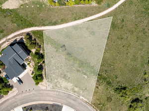 Aerial view of property and surrounding area featuring property parcel outlined