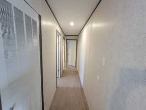 Corridor with a heating unit and light colored carpet