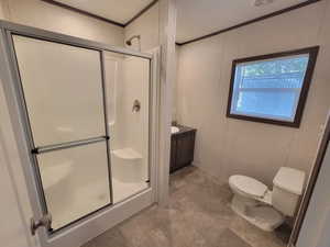 Full bath with a stall shower, toilet, ornamental molding, and vanity