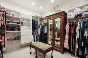 Spacious closet featuring carpet flooring