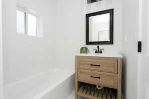 Bathroom with vanity and shower / bath combination