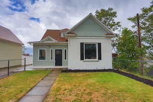 Victorian house featuring roof with shingles