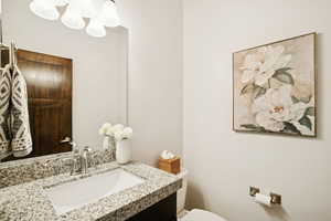 Bathroom featuring vanity and a chandelier