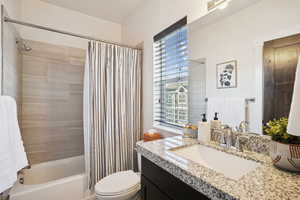 Bathroom featuring shower / tub combo and vanity