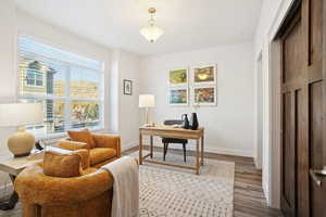 Home office with baseboards and light wood-type flooring