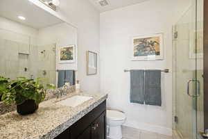 Bathroom featuring vanity, a shower stall, and light tile patterned flooring
