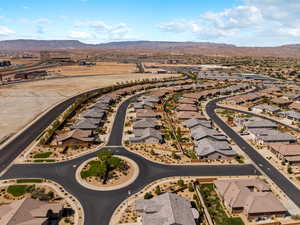 Aerial overview of property's location featuring a mountainous background and nearby suburban area