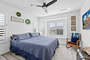 Bedroom featuring wood finished floors, baseboards, and ceiling fan