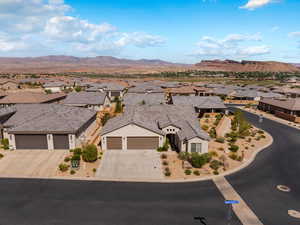 View of front of property featuring a residential view, a garage, concrete driveway, and a mountain view