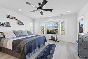 Bedroom featuring light wood-style floors, recessed lighting, a ceiling fan, and baseboards