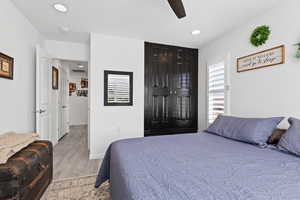 Bedroom with light wood-style floors, recessed lighting, baseboards, and a ceiling fan