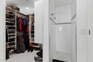 Walk in closet with marble finish flooring