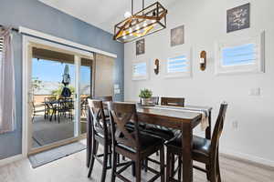 Dining space featuring plenty of natural light, baseboards, and a chandelier