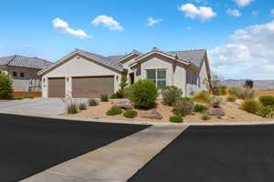 Ranch-style home with stucco siding, an attached garage, driveway, and a tile roof