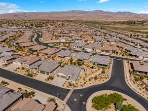 Aerial view of property's location featuring a mountainous background and nearby suburban area