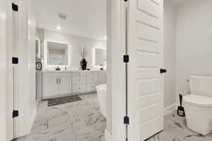 Full bath with marble finish floors, baseboards, double vanity, toilet, and recessed lighting
