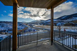 Snow covered back of property featuring a mountain view