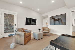 Living area featuring recessed lighting, light wood-type flooring, and vaulted ceiling