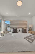 Bedroom featuring multiple windows and recessed lighting