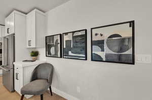 Living area featuring light wood-type flooring and baseboards