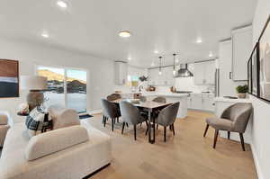 Dining room with recessed lighting, light wood finished floors, and baseboards