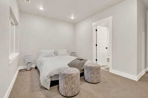 Carpeted bedroom with baseboards and recessed lighting