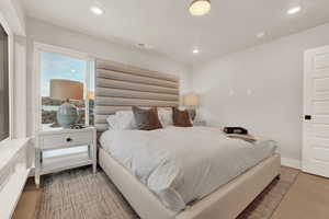 Bedroom featuring recessed lighting, wood finished floors, and baseboards