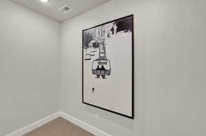 Detailed view of baseboards, carpet flooring, and recessed lighting