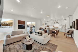 Living area featuring light wood-type flooring, recessed lighting, and baseboards