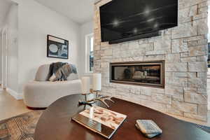 Living area featuring baseboards and a fireplace