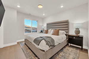 Bedroom featuring baseboards, light wood-style flooring, and recessed lighting