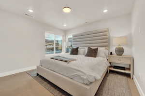 Bedroom featuring wood finished floors, baseboards, and recessed lighting