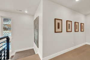 Hallway featuring baseboards and recessed lighting