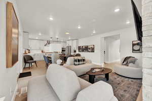 Living area featuring baseboards, recessed lighting, and light wood-style floors