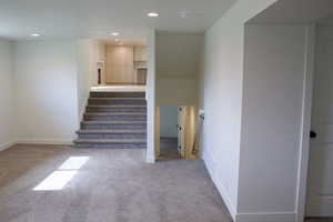 Stairway looking up into the kitchen/living room on main floor and showing stairway to basement.