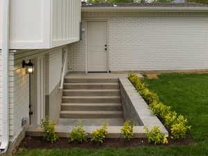 Backyard basement entrance tastefully done  with pavers
