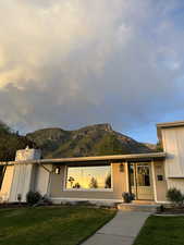 View of front of property with a mountain view behind