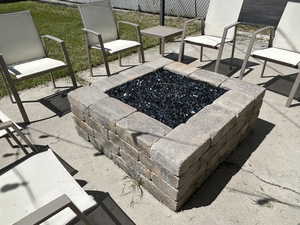 Gas firepit on back patio comes with patio furniture and party lights.